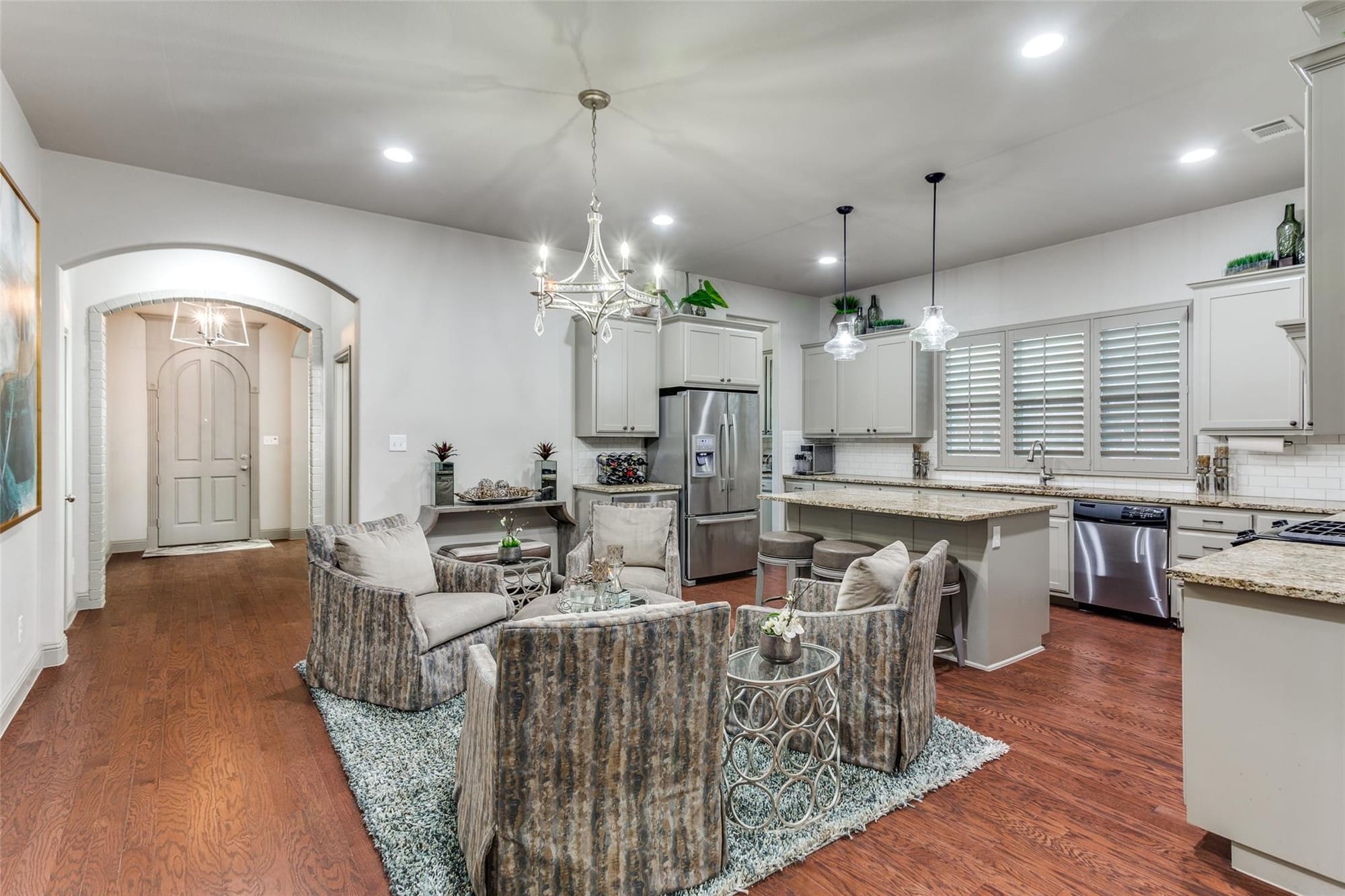 Central conversation area inside 5624 Pershing Avenue, a Westside Fort Worth home, connecting the entry, kitchen, living room, and dining room.