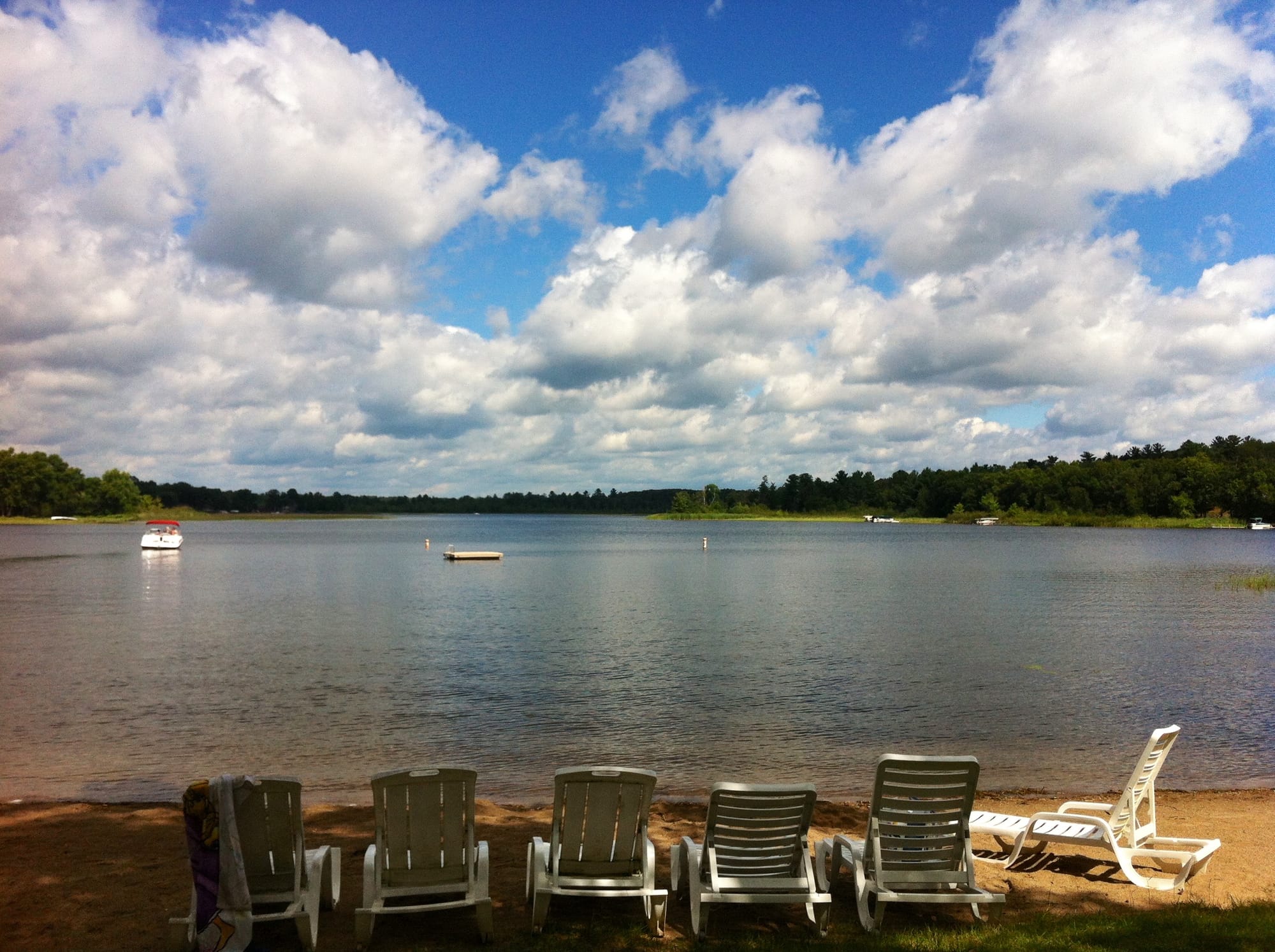 A nostalgic childhood photo of Adirondack chairs by a lake, the personal design inspiration for Comfort Is Created's staging of the Al Komatsu-designed lake house at 13030 Miller Road.