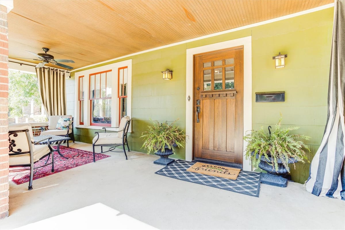 Colorful Craftsman-style home with a large front porch in the Ryan Place neighborhood of Fort Worth, Texas.