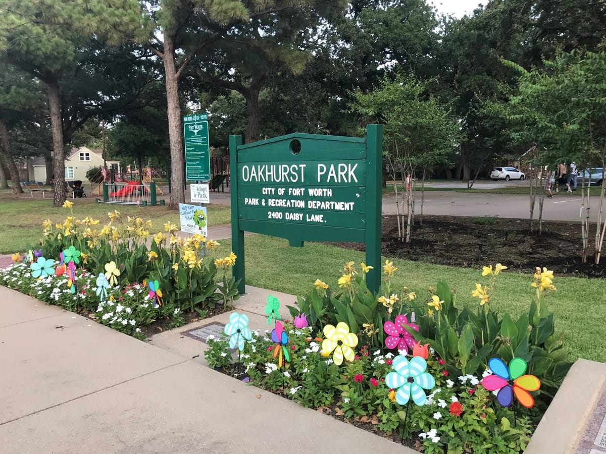 Sign for Oakhurst Park in the Oakhurst neighborhood of Fort Worth, Texas, a location for neighborhood events and holiday celebrations.